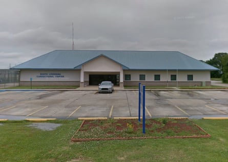 Flat landscape, with small parking lot and really quite small one-story building with peaked roof. Does not look like a jail.