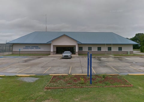 Flat landscape, with small parking lot and really quite small one-story building with peaked roof. Does not look like a jail.