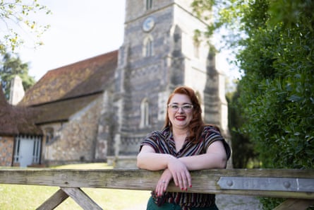 Anna Vine leaning on a gate outside All Saints Church