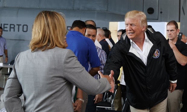 Donald Trump shakes hands with San Juan’s mayor, Carmen Yulín Cruz. After he criticized Cruz on Twitter, Russian-linked Twitter accounts disseminated articles focused on discrediting her, analysts say.