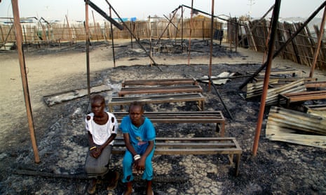 Girls sit amid the ruins of a primary school burned down in fighting at the Malakal protection of civilians site in South Sudan
