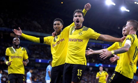 Borussia Dortmund's Jude Bellingham (centre left) celebrates scoring against Manchester City with Mats Hummels.