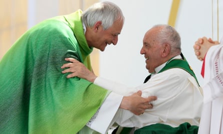 Cardinal Matteo Zuppi greets Pope Francis,.