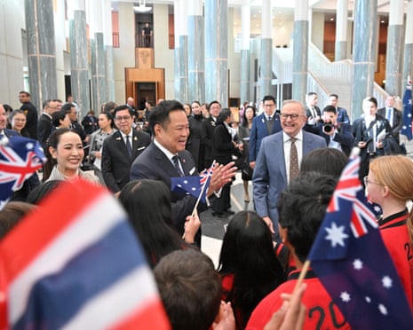 Anthony Albanese with Thai Prime Minister Anutin Charnvirakul and his wife Thananon Charnvirakul greeted by schoolchildren in the Parliament House foyer