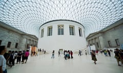 People walking in the British Museum with its arched ceiling in the Great Court and curved-walled Reading Room