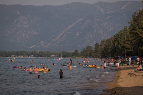 Pope Beach on Lake Tahoe is crowded with people swimming and basking in the sun.