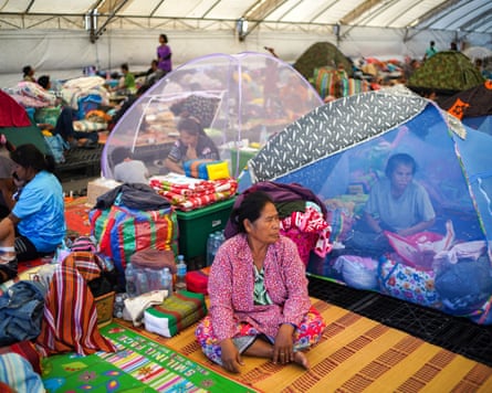 Displaced people gather inside a temporary shelter in Buriram province, Thailand
