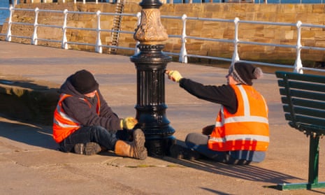 Two offenders on the Community Payback scheme, administered by the Probation Service, painting a lamppost on Whitby Pier.