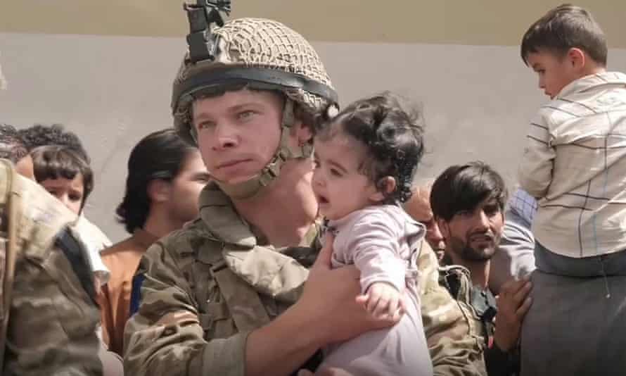 A British soldier with a baby at Kabul airport