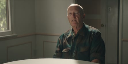 man in flannel speaks as he sits at table