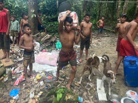 Aldeões Yanomami levam suprimentos de um garimpo ilegal invadido por tropas ambientais perto da aldeia de Xitei.