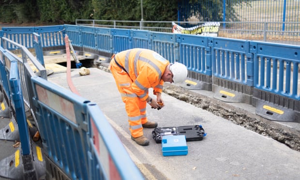 Worker repairing leaking pipes.