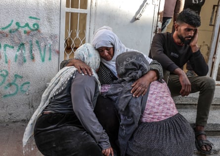 Women hold each other in grief