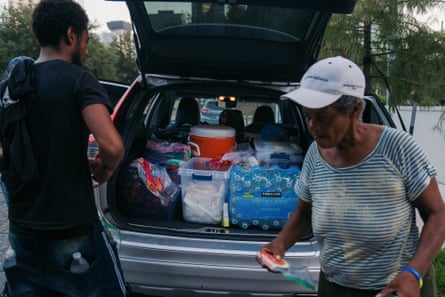 water and other supplies in the back of a car