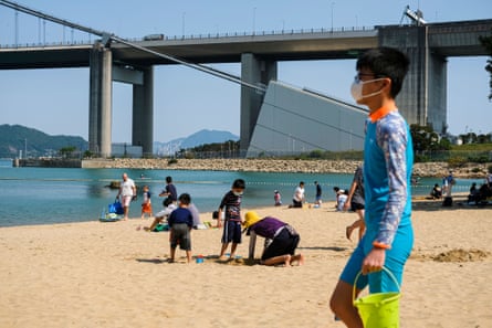 Beachgoers in Hong Kong make the most of the good weather.