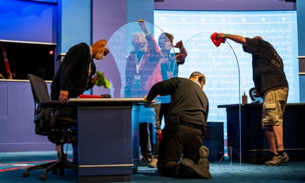 Workers install plexiglass panels between the candidates’ desks for the 2020 vice-presidential debate.