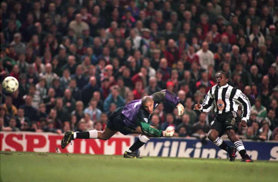 Faustino Asprilla scoring past Liverpool goalkeeper David James in 1996.