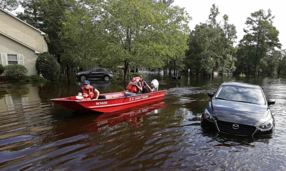 Members of the US Coast Guard check on a flooded neighborhood in Lumberton, North Carolina Monday.