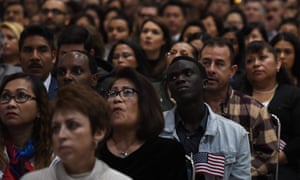 US immigrants prepare to pledge allegiance as they receive citizenship at a naturalization ceremony in Los Angeles. 
