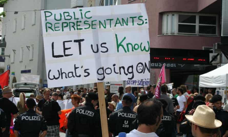Protesters march in Austria against lobbying taking place at the Bilderberg summit.