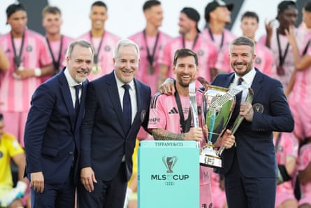 Inter Miami owners Jose Mas (left) his brother Jorge Mas and David Beckham pose with the MLS Cup trophy with Lionel Messi in December 2025.