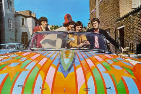 Four men in an open top multicoloured car
