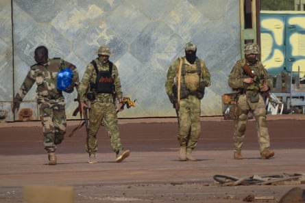 This undated photograph handed out by French military shows three Russian mercenaries, right, in northern Mali.