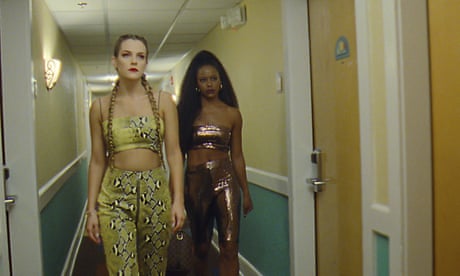 This image released by A24 shows Riley Keough, left, and Taylour Paige in a scene from “Zola.” (A24 Films via AP)