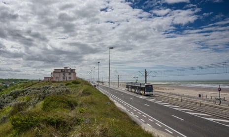 The Belgum, Coastal Tram, the Kusttram on its journey by the sea on a cloudy and blue-sky day.