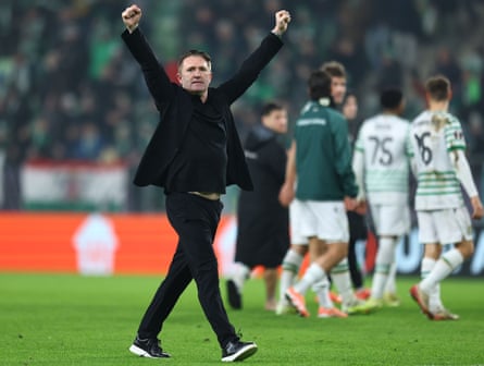 Ferencvaros head coach Robbie Keane raises his arms aloft at the full time whistle.