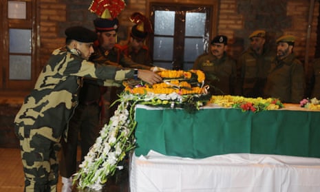 An Indian officer lays a wreath on the coffin of deputy superintendent of police Aman Thakur in Kashmir on Sunday