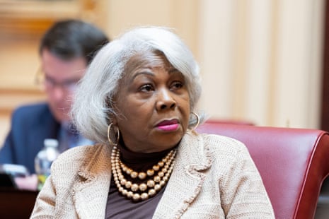 a woman looks ahead while seated