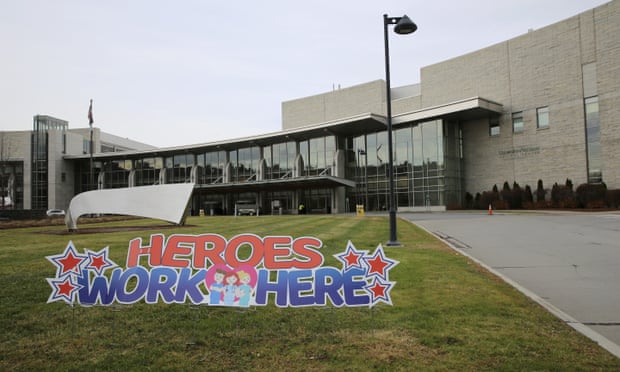 exterior of building with sign out front that says 'heroes work here'