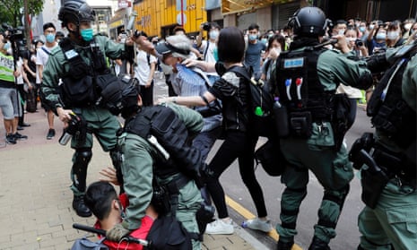 Anti-government demonstrators scuffle with riot police during a lunchtime protest in Hong Kong