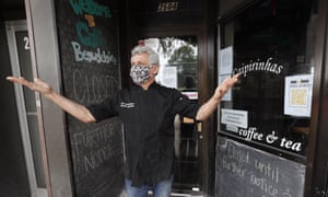 A restaurateur stands in front of his temporarily closed venue in Ames, Iowa.