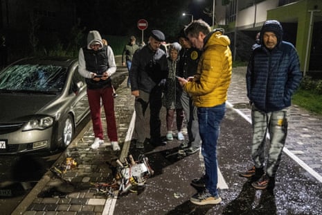 Kyiv residents inspect the remains of a drone following an attack on the city.