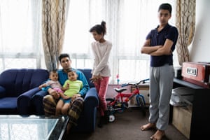 Samir Uddin with his children from the series Lived Brutalism: photographs of residents of the Robin Hood Gardens housing estate by photographer Kois Miah