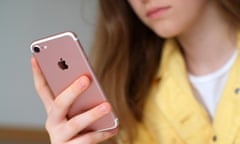 Young girl (teenager) holding rose gold iPhone in right hand