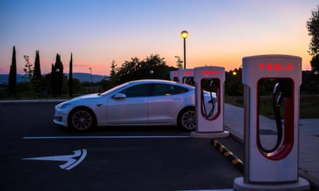 A Tesla Model S charges at a charging station.