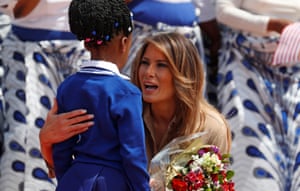 The US first lady, Melania Trump, greets a child in Lilongwe, Malawi, on the second stop on her Africa tour.