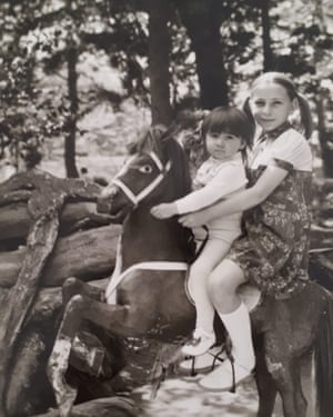 Children photographed on a toy horse in Tbilisi zoo by photographer Victor Sukiasov from the online archive zoophotography.ge