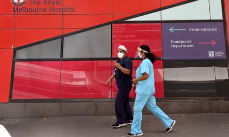 Medical staff walk past the emergency entrance at the Royal Melbourne hospital