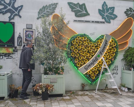 A large heart filled with sunflowers at a memorial wall dedicated to the victims and survivors