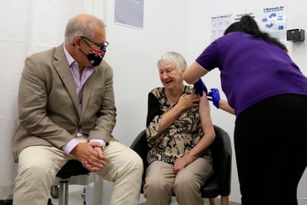Jane Malysiak receives Australia’s first Covid-19 vaccination as Scott Morrison looks on at a Sydney medical centre