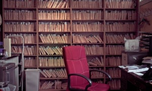 A wall lined with shelves housing thousands of brown paper files, dating back to 1987, containing Dr Zigmond’s handwritten comments