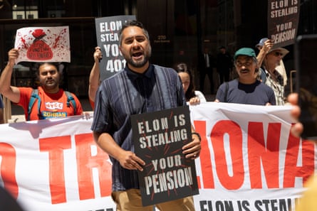 Demonstrators hold signs outside that say ‘Elon is stealing from your pension’