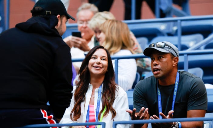 Tiger Woods and his girlfriend chat with Alexis Ohanian, husband of Serena Williams, before the match begins.