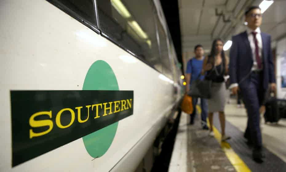 Passengers disembark a Southern train at Victoria Station in London