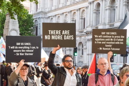 Protesters hold signs outside Downing Street