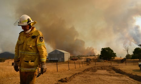 Rural Fire Service firefighter Trevor Stewart views a fire on 11 January in Tumburumba, Australia.